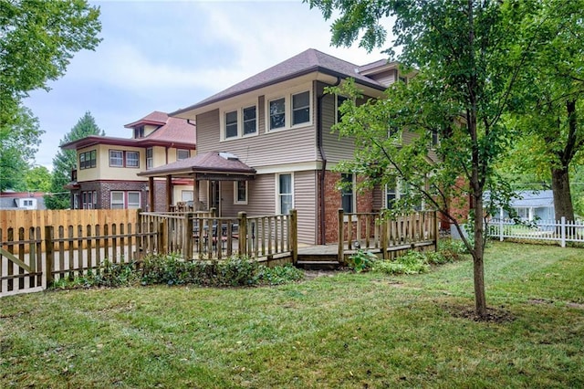 view of front of house featuring a front lawn and a wooden deck