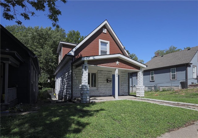 view of front of home with a porch and a front yard