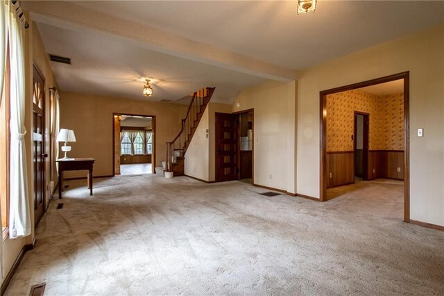 unfurnished living room with light carpet