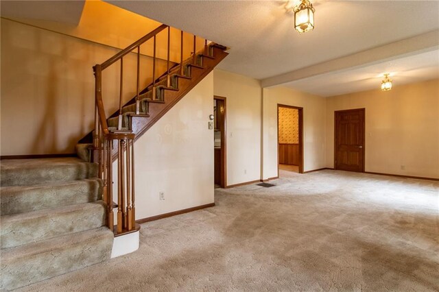 interior space with carpet flooring and beamed ceiling