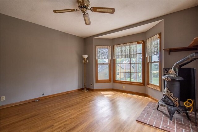 interior space featuring light wood-type flooring, ceiling fan, and a healthy amount of sunlight