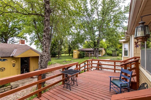 deck with a lawn and a shed