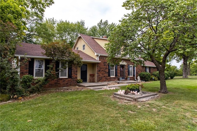 view of front of home with brick siding and a front lawn