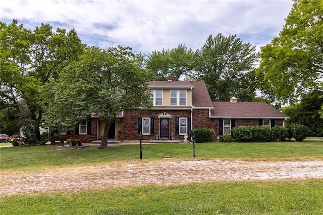 view of front facade featuring brick siding and a front lawn