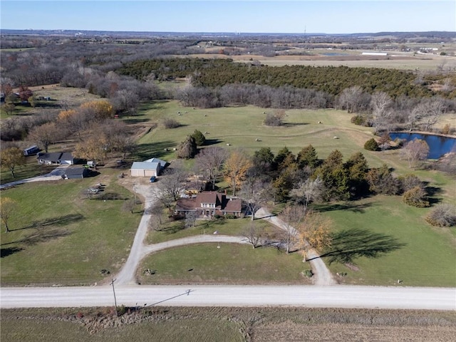 birds eye view of property with a rural view and a water view