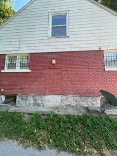 view of property exterior with brick siding