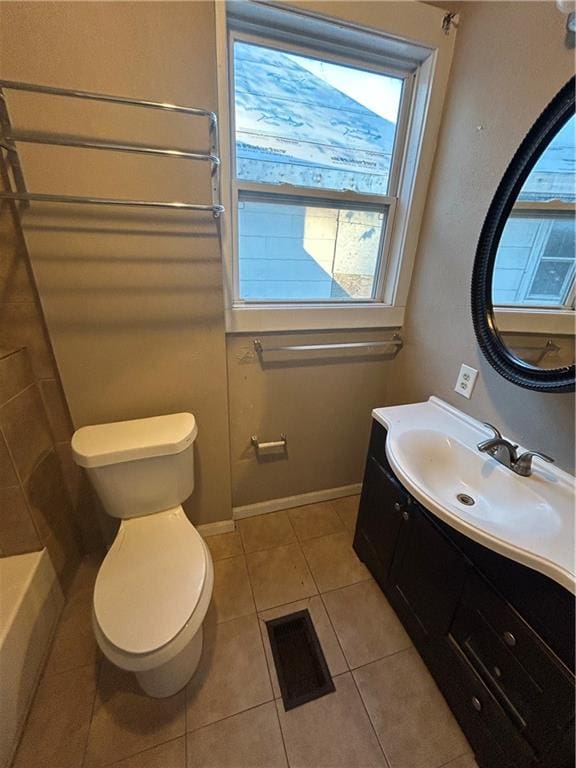 bathroom featuring tile patterned flooring, toilet, vanity, visible vents, and baseboards