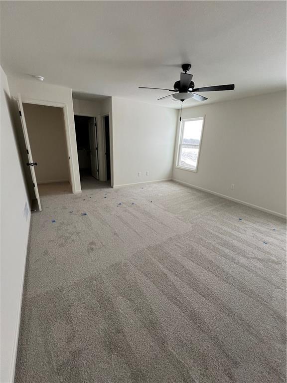 carpeted empty room with ceiling fan