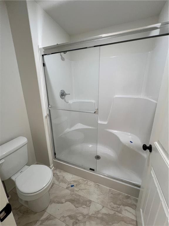 bathroom with toilet and walk in shower