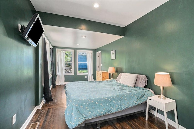 bedroom with recessed lighting, visible vents, baseboards, and wood finished floors