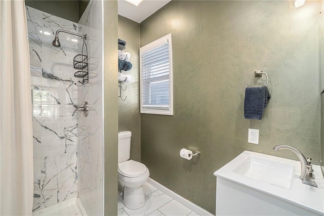 full bath with toilet, marble finish floor, a marble finish shower, and a sink