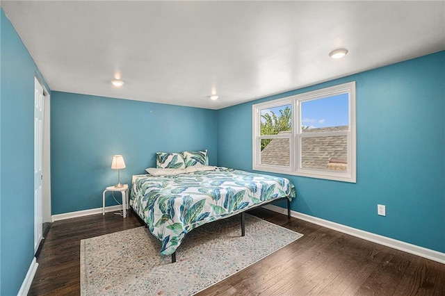 bedroom featuring baseboards and wood finished floors