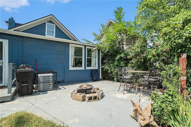 view of patio featuring central AC unit and an outdoor fire pit