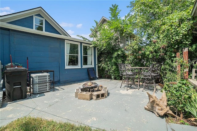 view of patio / terrace featuring central AC unit and a fire pit