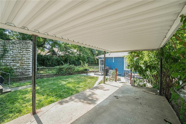 view of patio with an outdoor structure and fence