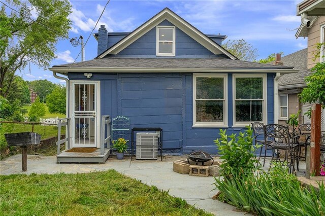 2937 Paseo Blvd, Kansas City, MO 64109 - rear view of property with an outdoor fire pit, a patio, roof with shingles, and a chimney