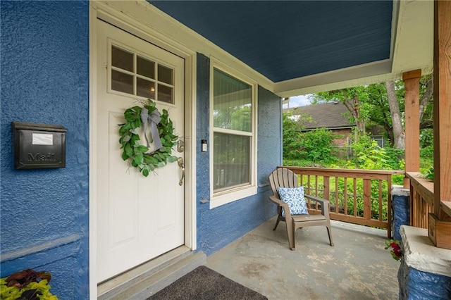 2937 Paseo Blvd, Kansas City, MO 64109 - entrance to property featuring covered porch and stucco siding