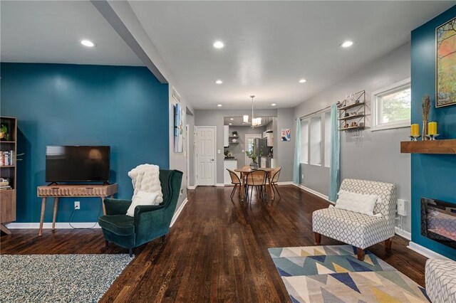 2937 Paseo Blvd, Kansas City, MO 64109 - living area featuring wood finished floors, a glass covered fireplace, recessed lighting, and baseboards