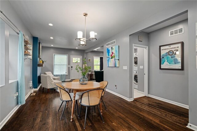 2937 Paseo Blvd, Kansas City, MO 64109 - dining area featuring estacked washer and dryer, wood finished floors, a chandelier, baseboards, and recessed lighting
