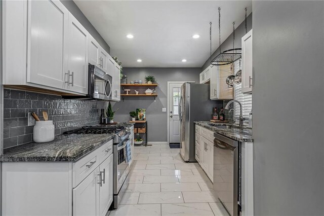 2937 Paseo Blvd, Kansas City, MO 64109 - kitchen with stainless steel appliances, a sink, open shelves, light marble finish flooring, and tasteful backsplash