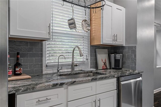 2937 Paseo Blvd, Kansas City, MO 64109 - kitchen with a sink, dishwasher, white cabinets, and backsplash