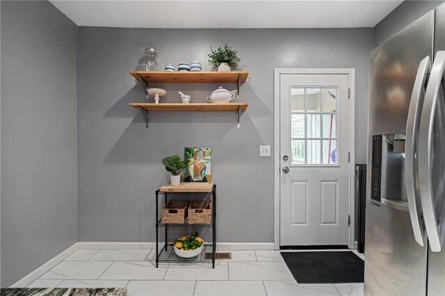 2937 Paseo Blvd, Kansas City, MO 64109 - doorway to outside with light marble finish floors and baseboards