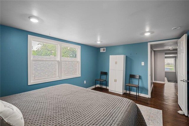 2937 Paseo Blvd, Kansas City, MO 64109 - bedroom featuring dark wood finished floors and baseboards