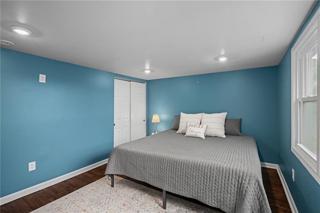 2937 Paseo Blvd, Kansas City, MO 64109 - bedroom with wood finished floors, baseboards, and a closet