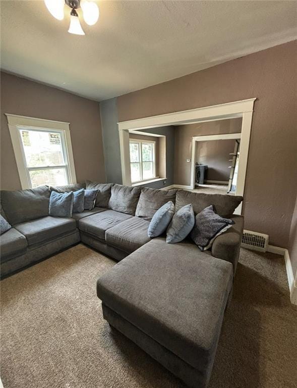 living room with carpet and a healthy amount of sunlight