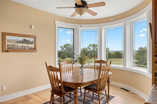 dining space featuring ceiling fan, light hardwood / wood-style floors, and a healthy amount of sunlight