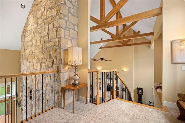 hallway with beamed ceiling and high vaulted ceiling