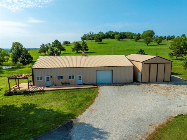 view of front of home featuring an outbuilding, a rural view, and a front yard