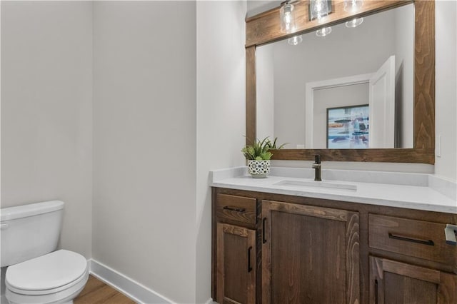 bathroom featuring hardwood / wood-style floors, vanity, and toilet