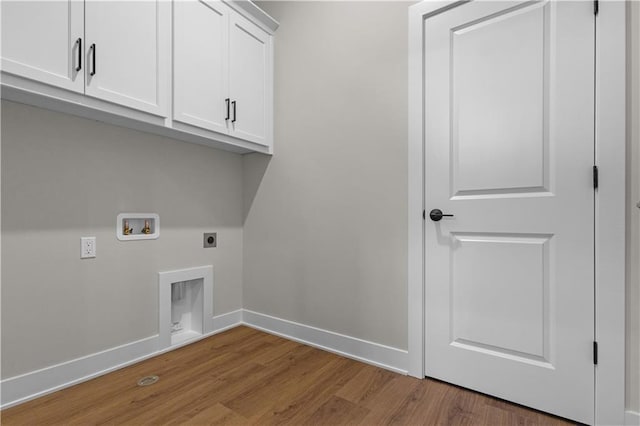 washroom with electric dryer hookup, cabinets, light hardwood / wood-style floors, and washer hookup