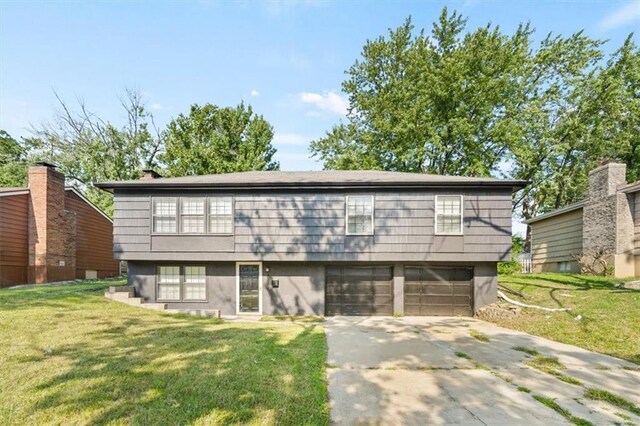 view of front facade with a garage and a front lawn