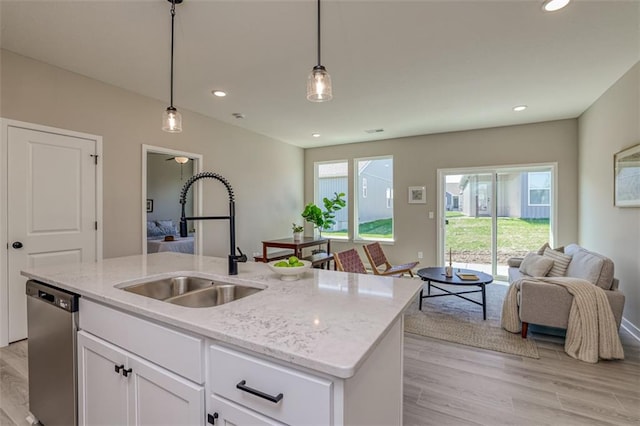 kitchen featuring white cabinetry, sink, plenty of natural light, and dishwasher