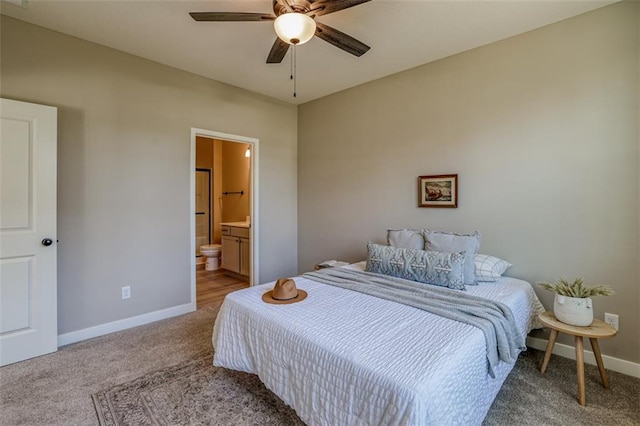 bedroom with carpet floors, ceiling fan, and ensuite bath