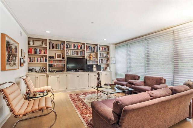 living area with light wood-style floors, crown molding, and recessed lighting