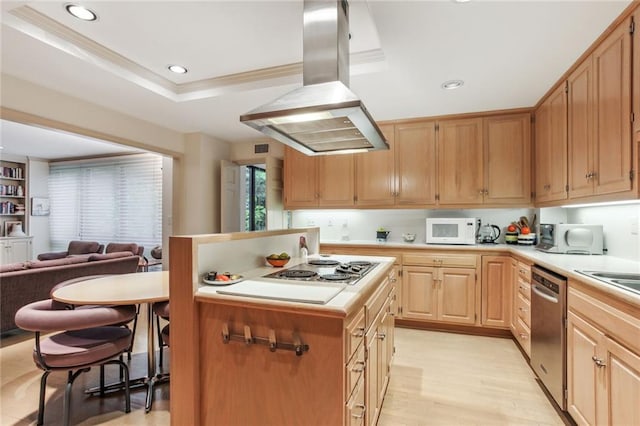 kitchen featuring island range hood, dishwasher, white microwave, light countertops, and light brown cabinetry