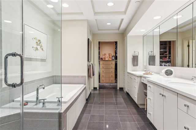 bathroom with a garden tub, coffered ceiling, vanity, tile patterned floors, and a walk in closet