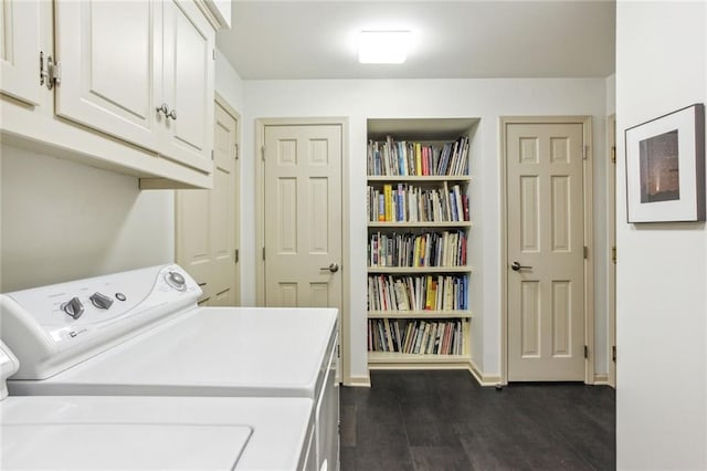 washroom featuring dark wood-type flooring, cabinet space, baseboards, and separate washer and dryer