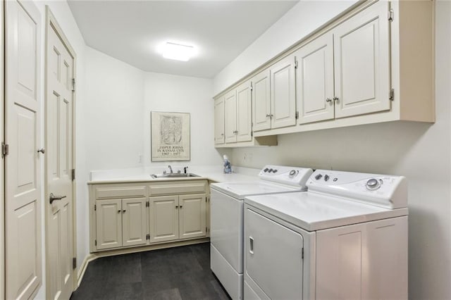 laundry room featuring a sink, cabinet space, dark wood-style flooring, and washer and dryer