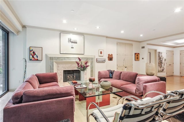 living area featuring light wood-type flooring, a high end fireplace, crown molding, and recessed lighting