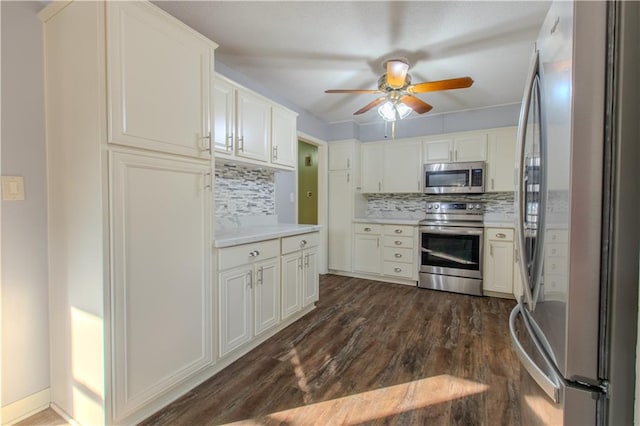 kitchen featuring dark hardwood / wood-style floors, appliances with stainless steel finishes, tasteful backsplash, ceiling fan, and white cabinets