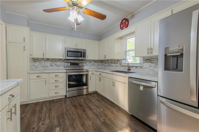 kitchen featuring stainless steel appliances, sink, dark hardwood / wood-style floors, and ceiling fan