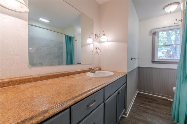 bathroom with vanity, toilet, curtained shower, and hardwood / wood-style flooring