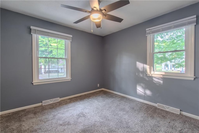 carpeted empty room featuring ceiling fan