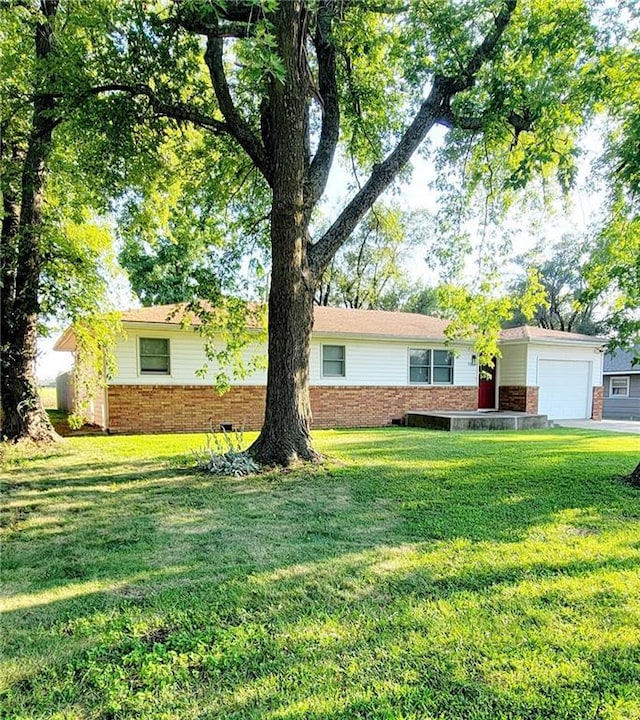 single story home with a garage and a front yard