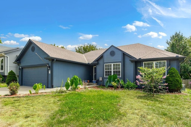 ranch-style house featuring a garage, a shingled roof, a front lawn, and concrete driveway