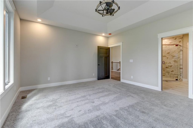 interior space with light colored carpet and ensuite bath